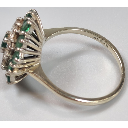 54 - 18ct white gold flowerhead cluster ring inset with thirteen emeralds and six diamonds. 4.8g approx. ... 