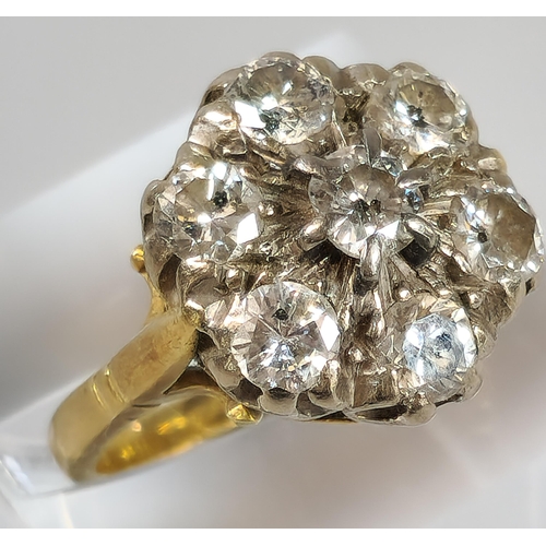 64 - 18ct gold diamond seven stone flowerhead cluster ring. 7.5g approx. Size O. (B.P. 21% + VAT)