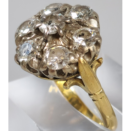 64 - 18ct gold diamond seven stone flowerhead cluster ring. 7.5g approx. Size O. (B.P. 21% + VAT)