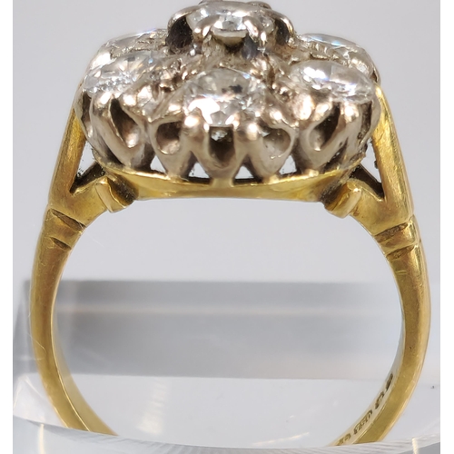 64 - 18ct gold diamond seven stone flowerhead cluster ring. 7.5g approx. Size O. (B.P. 21% + VAT)