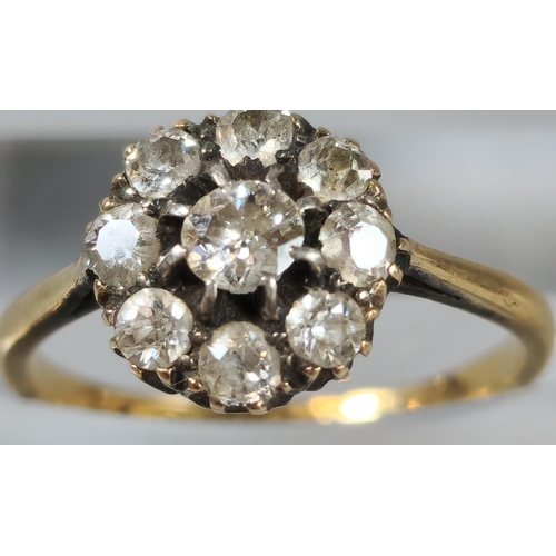 65 - 18ct gold nine stone flowerhead cluster ring. 2.1g approx. Size K1/2. (B.P. 21% + VAT)