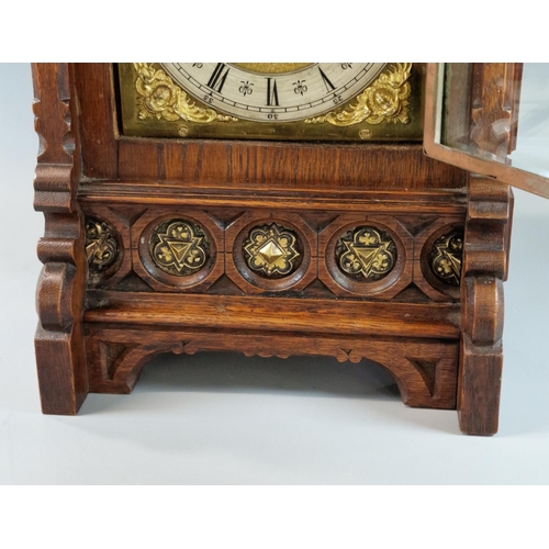 7 - Early 20th century oak two train architectural bracket clock, having Romanesque pediment with two ba... 