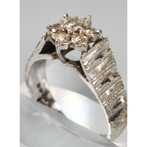 70 - 18ct white gold and diamond seven stone flowerhead ring. 5.5g approx. Size M. (B.P. 21% + VAT)