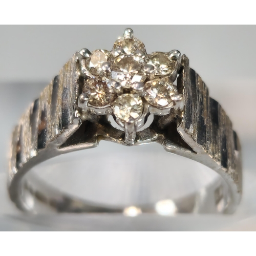 70 - 18ct white gold and diamond seven stone flowerhead ring. 5.5g approx. Size M. (B.P. 21% + VAT)