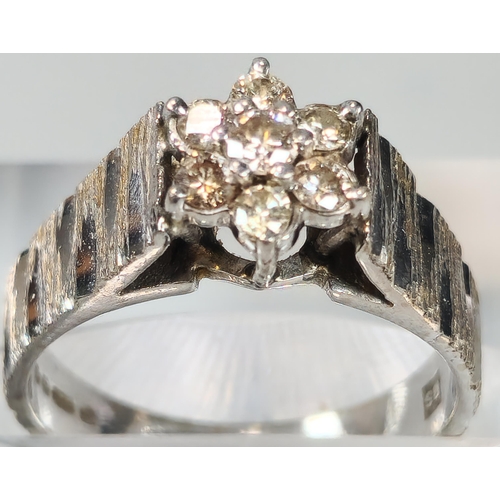 70 - 18ct white gold and diamond seven stone flowerhead ring. 5.5g approx. Size M. (B.P. 21% + VAT)