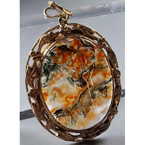 75 - 9ct gold ornate oval pendant inset with cabochon agate stone. Total weight 17.5g approx. 5.5x3.5cm a... 