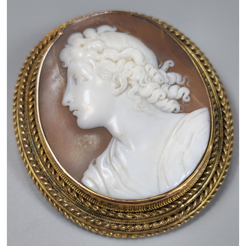 77 - Two gold Victorian cameo brooches of circular and oval form, one depicting Aurora Goddess of Dawn, t... 