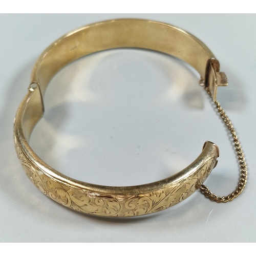 84 - 9ct gold engraved bangle. 6.5cm diameter approx. 18g approx.   (B.P. 21% + VAT)