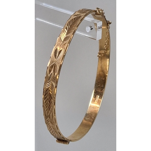 85 - 9ct gold engraved christening bangle. 6cm diameter approx. 11.5g approx.   (B.P. 21% + VAT)