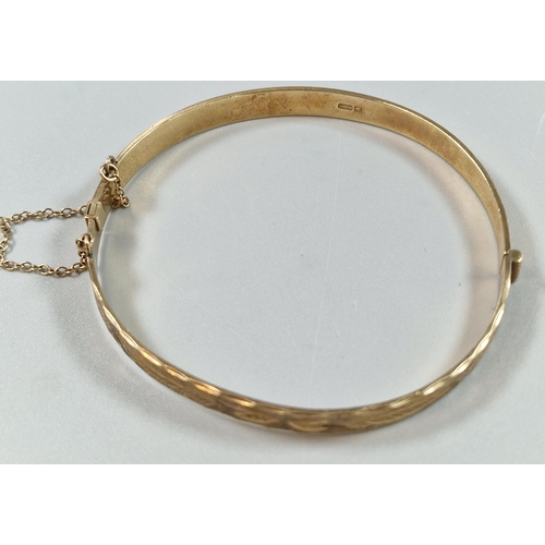 85 - 9ct gold engraved christening bangle. 6cm diameter approx. 11.5g approx.   (B.P. 21% + VAT)