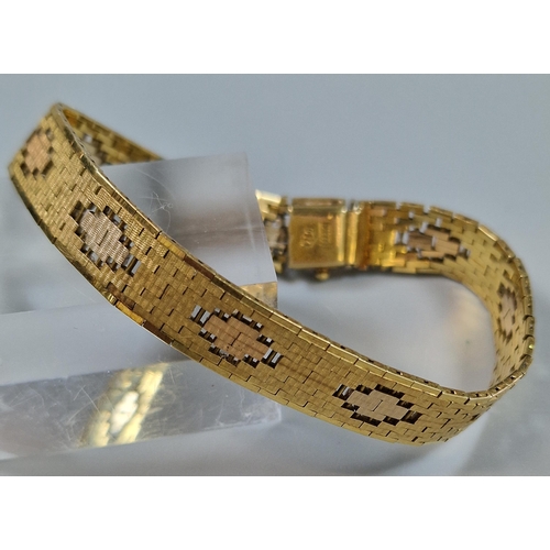 86 - 18ct gold articulated flat weave design ladies' bracelet with repeating geometric designs. Marked 75... 