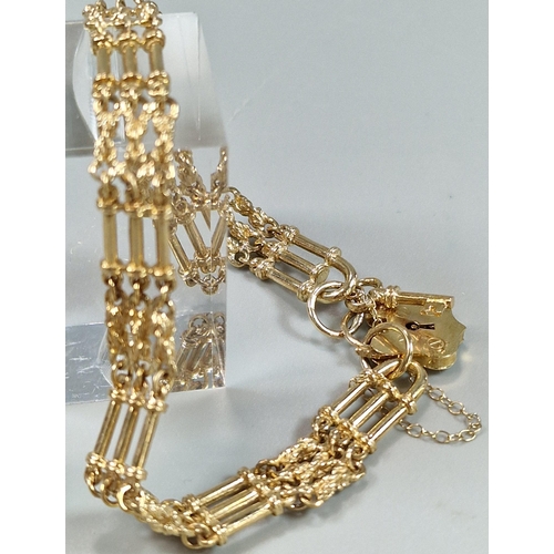 89A - 9ct gold three bar gate bracelet with shield padlock. 19g approx. (B.P. 21% + VAT)