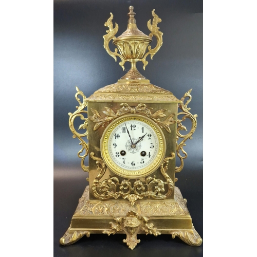 8A - Early 20th century French repoussé brass mantle clock, having urn finial over ceramic Arabic face, o... 