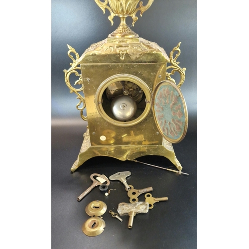 8A - Early 20th century French repoussé brass mantle clock, having urn finial over ceramic Arabic face, o... 