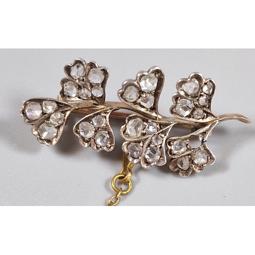 93 - Yellow metal flower spray brooch set with twenty eight diamonds (one missing). 3.4cm long approx. 2.... 