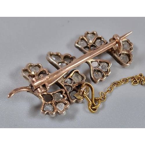 93 - Yellow metal flower spray brooch set with twenty eight diamonds (one missing). 3.4cm long approx. 2.... 