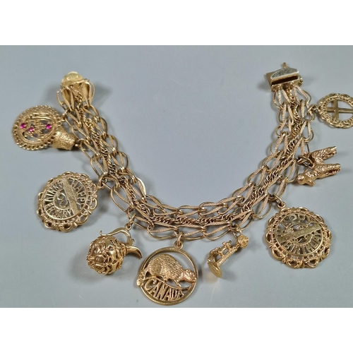 98 - 10ct gold charm bracelet, the charms including: 'Happy Birthday', 'Happy Anniversary', 'Mother' set ... 