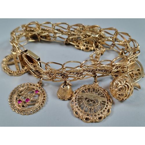 98 - 10ct gold charm bracelet, the charms including: 'Happy Birthday', 'Happy Anniversary', 'Mother' set ... 