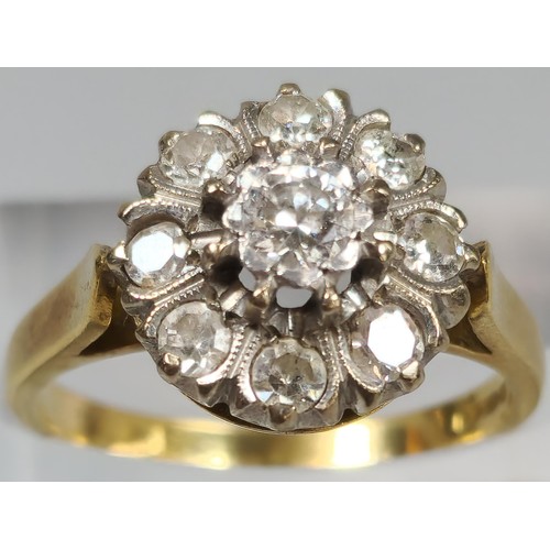 59 - 18ct gold diamond flowerhead cluster ring inset with nine diamonds. 6.5g approx. (B.P. 21% + VAT)