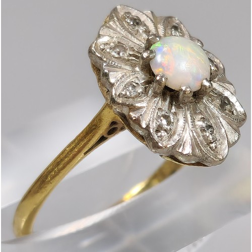 61 - 18ct gold ring inset with eight diamonds and central cabochon opal stone. 4.2g approx. Size M. (B.P.... 