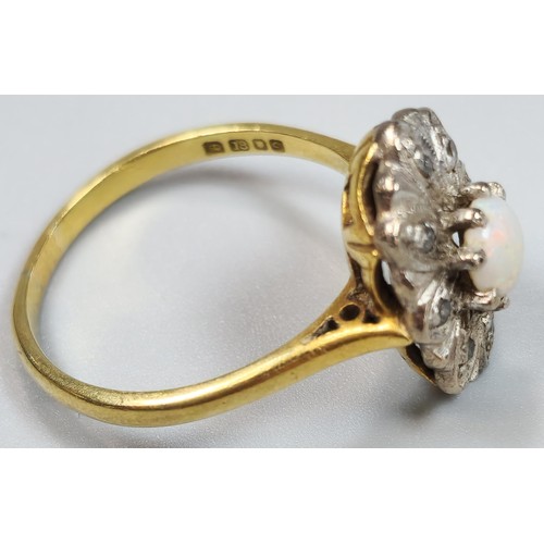 61 - 18ct gold ring inset with eight diamonds and central cabochon opal stone. 4.2g approx. Size M. (B.P.... 