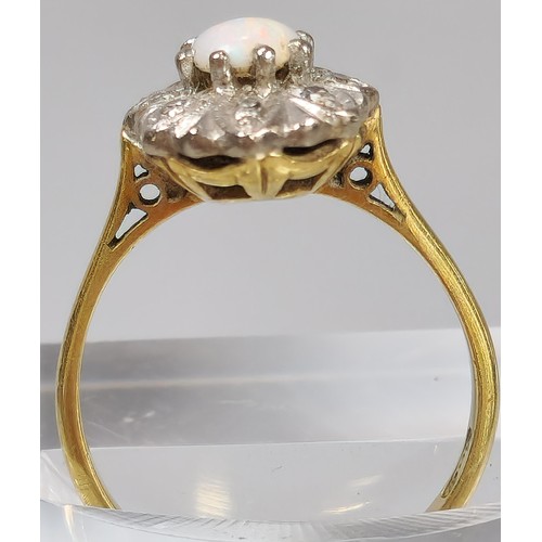 61 - 18ct gold ring inset with eight diamonds and central cabochon opal stone. 4.2g approx. Size M. (B.P.... 