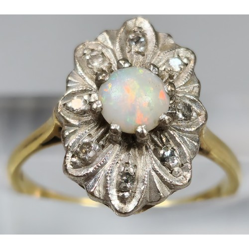 61 - 18ct gold ring inset with eight diamonds and central cabochon opal stone. 4.2g approx. Size M. (B.P.... 