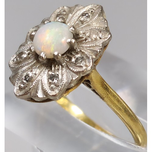 61 - 18ct gold ring inset with eight diamonds and central cabochon opal stone. 4.2g approx. Size M. (B.P.... 