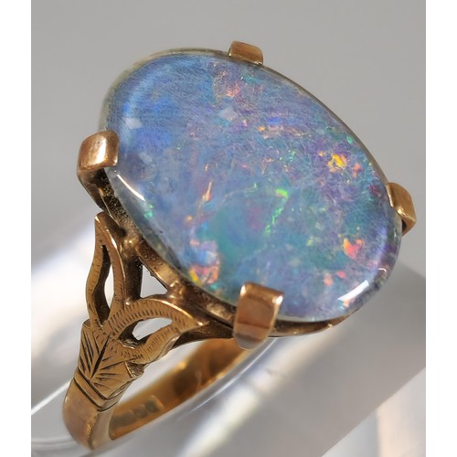 63 - 9ct gold ring inset with large opal cabochon stone, 1.8x1.1cm approx. 5.4g approx. Size M1/2. (B.P. ... 