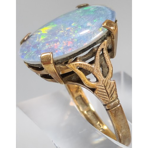 63 - 9ct gold ring inset with large opal cabochon stone, 1.8x1.1cm approx. 5.4g approx. Size M1/2. (B.P. ... 