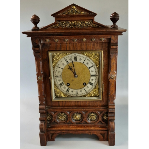 7 - Early 20th century oak two train architectural bracket clock, having Romanesque pediment with two ba... 