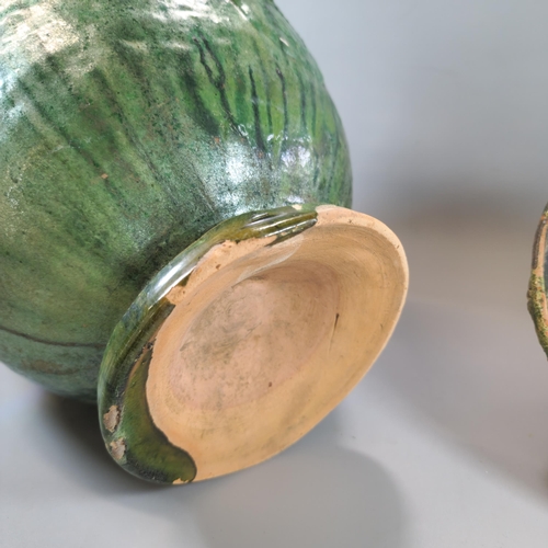 203 - Pair of Chinese terracotta Buddhist 'Offering Jars', with applied medallions, all covered in a vibra... 