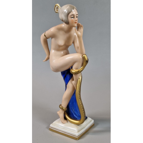 10 - Continental probably German porcelain study of a nude lady snake charmer on stepped base, green prin... 