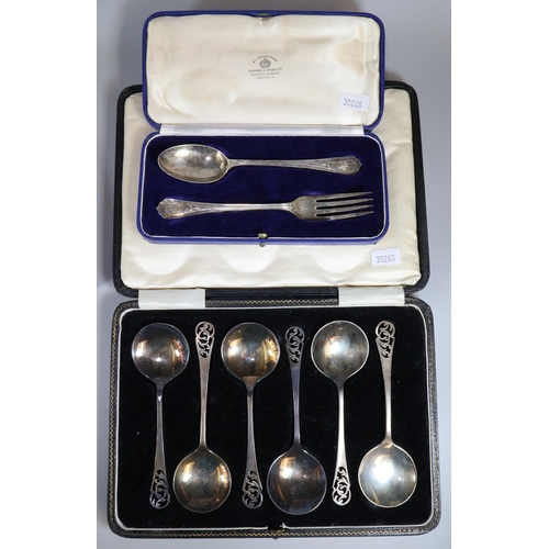 218 - Collection of cased silver to include: pair of butter knives, christening spoon and fork set, set of... 