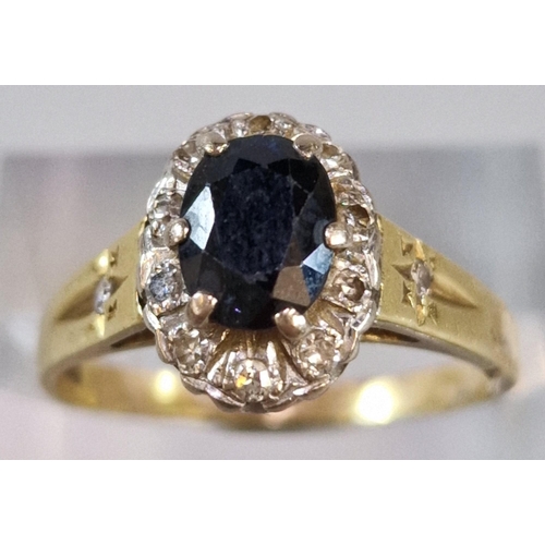 227 - 18ct gold diamond and sapphire cluster ring with tiny diamond chips to the shoulders. 4.5g approx. S... 