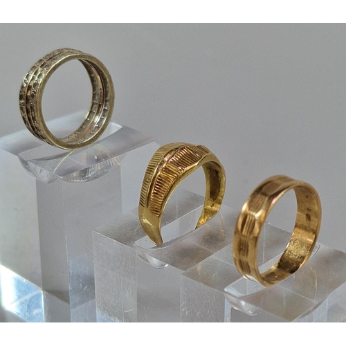 244 - 9ct gold eternity style ring together with two yellow metals rings. Total weight 9g approx. (3) (B.P... 