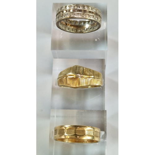 244 - 9ct gold eternity style ring together with two yellow metals rings. Total weight 9g approx. (3) (B.P... 