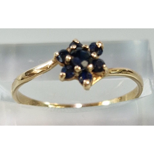 260 - 9ct gold seven stone flowerhead ring. 1g approx. Size O1/2. (B.P. 21% + VAT)