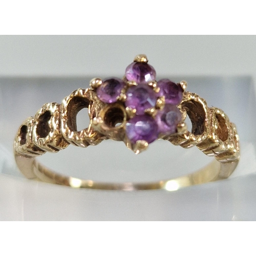 266 - 9ct gold and purple stone flowerhead ring (missing one stone). 2.3g approx. Size J1/2. (B.P. 21% + V... 