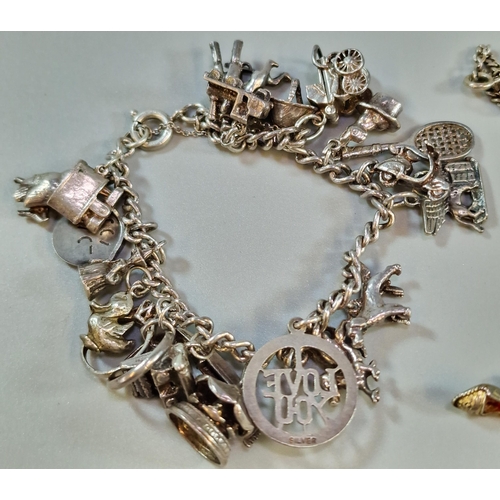 284 - Collection of silver to include: charm bracelets, loose charms, chain with crucifix cross etc. Total... 