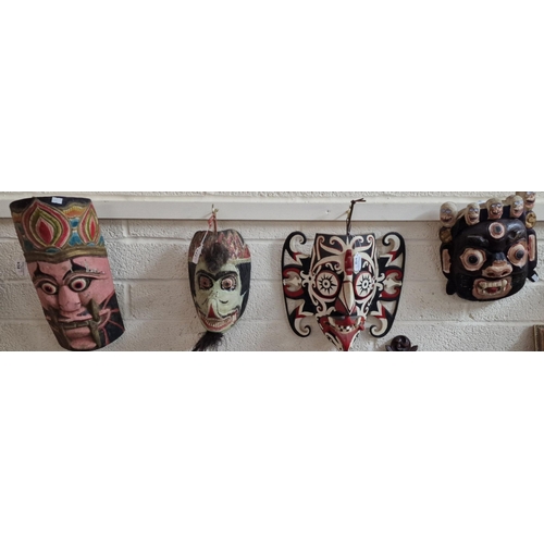 438 - Collection of eight hand-carved wooden and polychrome decorated African and Asian traditional tribal... 