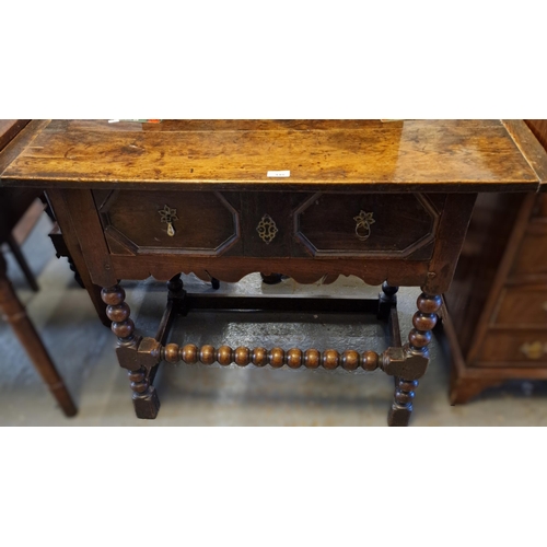 448 - Jacobean style oak single drawer side table with three plank cleated top above bobbin turned support... 