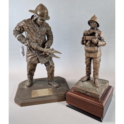 46 - Two modern bronzed figures of fire fighters, one larger with pneumatic cutters, the other in breathi... 