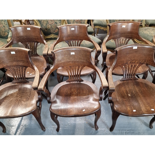 482 - Set of nine early 20th century oak office armchairs with splayed back splats and moulded saddle seat... 