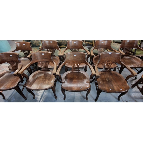 482 - Set of nine early 20th century oak office armchairs with splayed back splats and moulded saddle seat... 