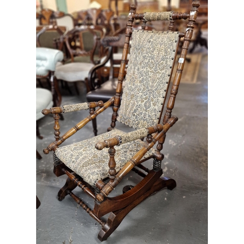 487 - Early 20th century stained walnut aesthetic design American style rocking armchair. (B.P. 21% + VAT)