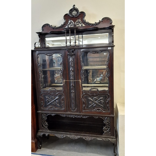 505 - Edwardian stained mahogany ornately carved display cabinet with mirrored back gallery above two door... 