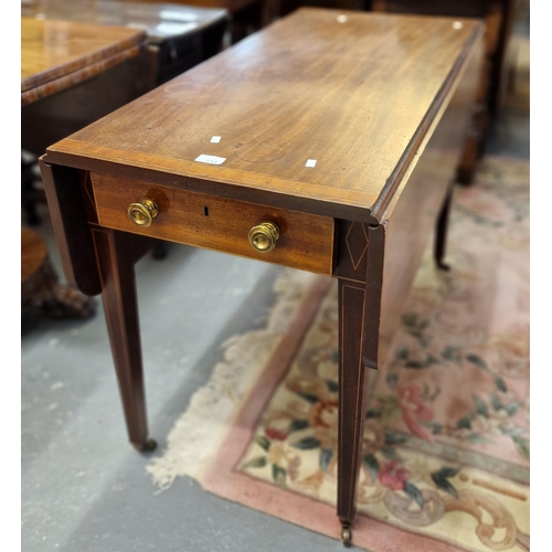 511 - Edwardian mahogany cross banded Pembroke table on square tapering legs and casters.  (B.P. 21% + VAT... 