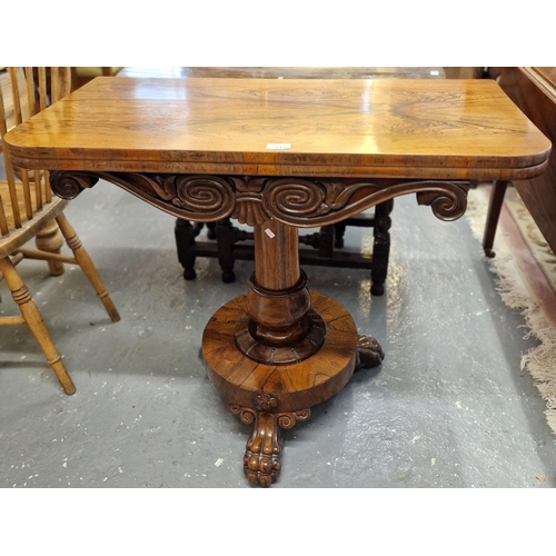 512 - 19th century rosewood fold-over card table, the red baize above carved frieze with baluster pedestal... 