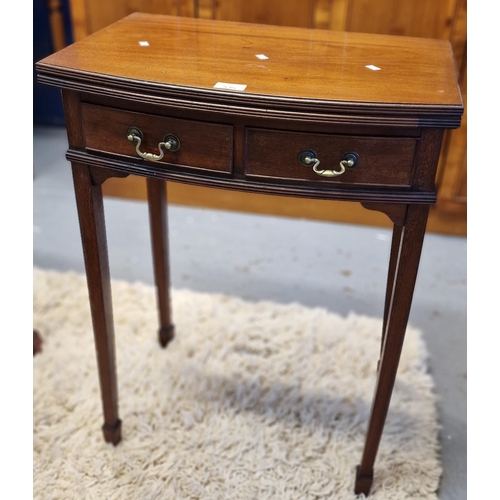 535 - Edwardian mahogany bow front fold-over card table, the green baize above two cock beaded drawers sta... 